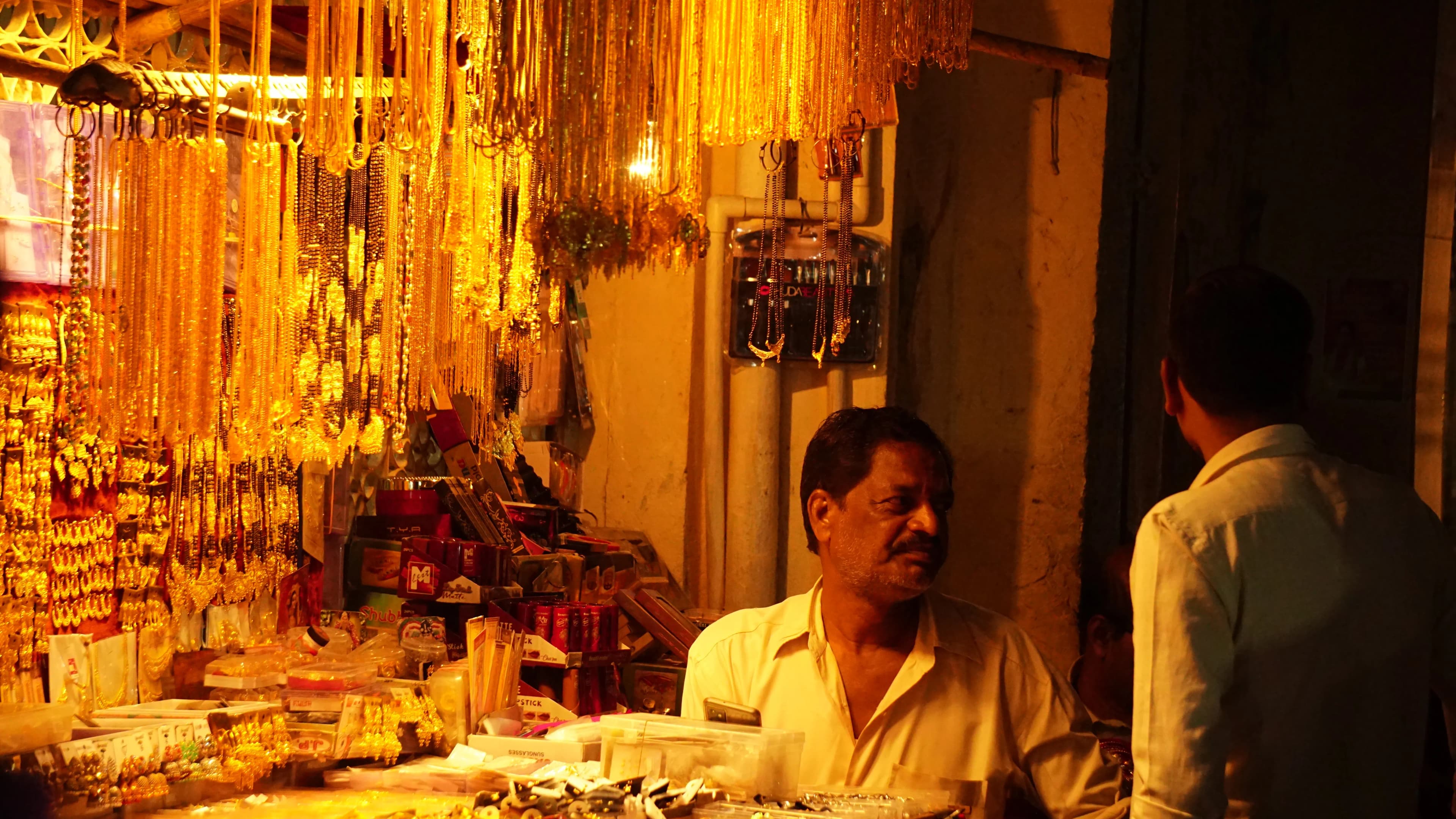 A bangle shop still glowing long after dark