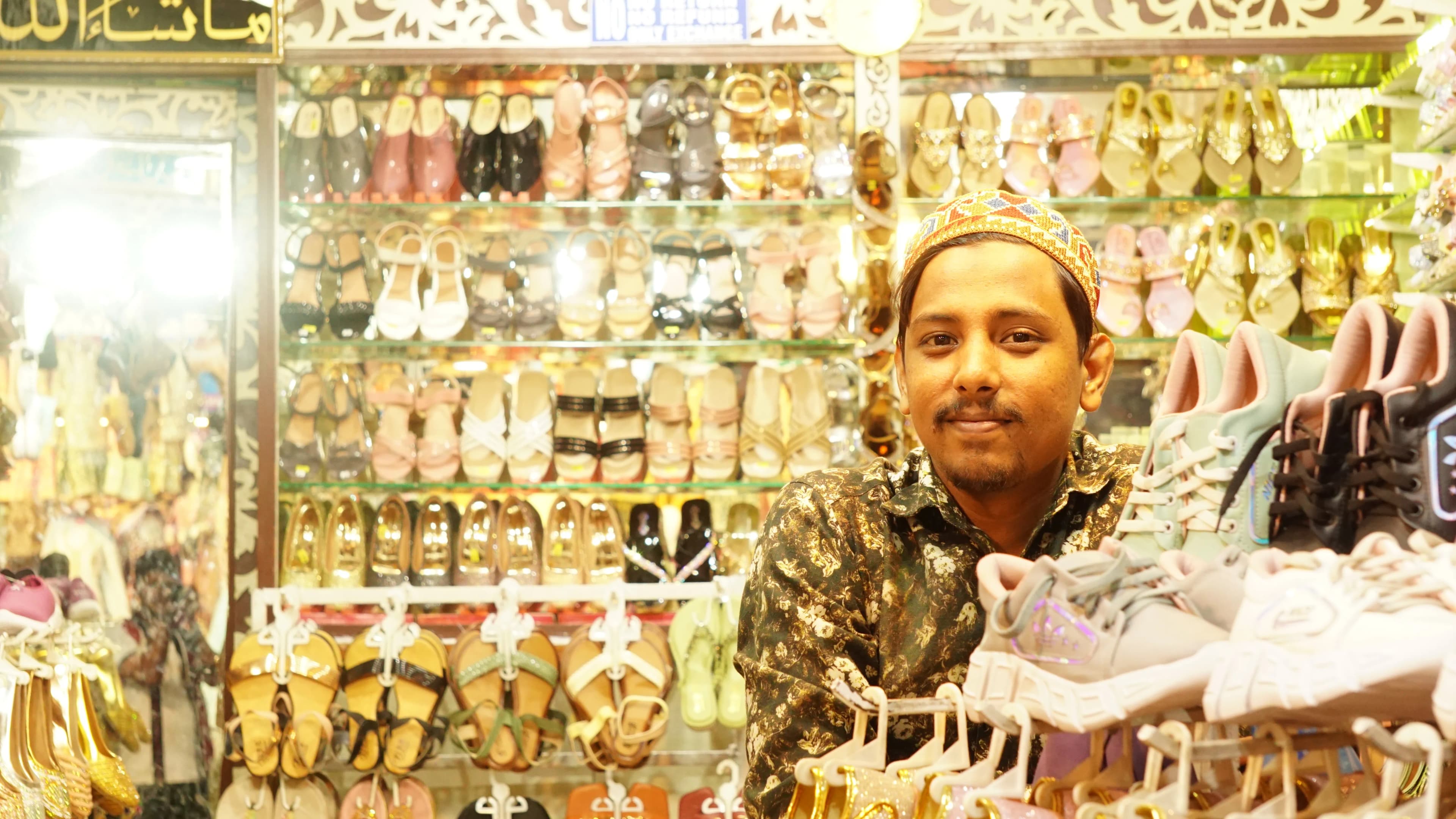 The sandal shop owner, happy to pose