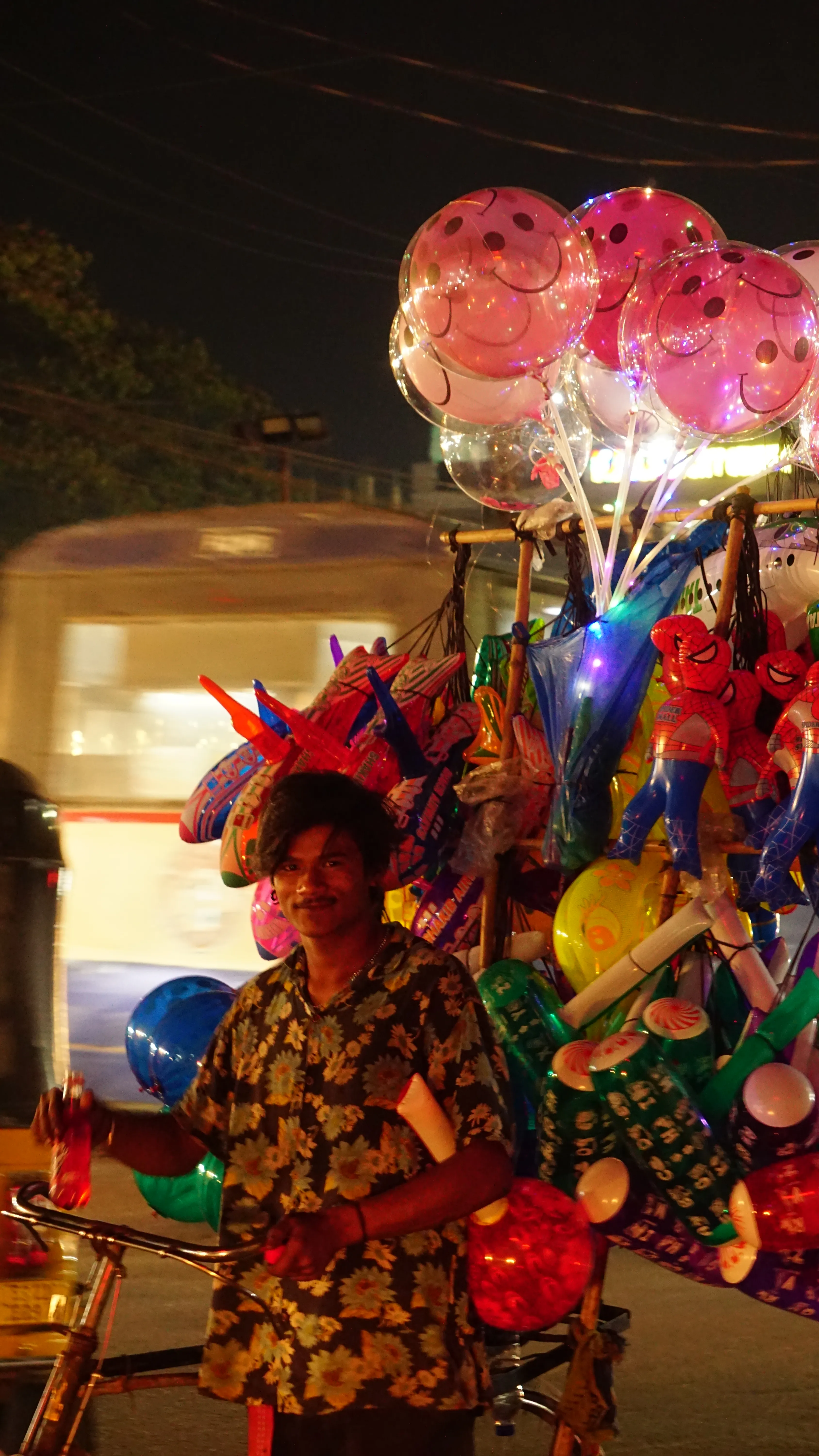 The balloon seller, holding up the whole night sky