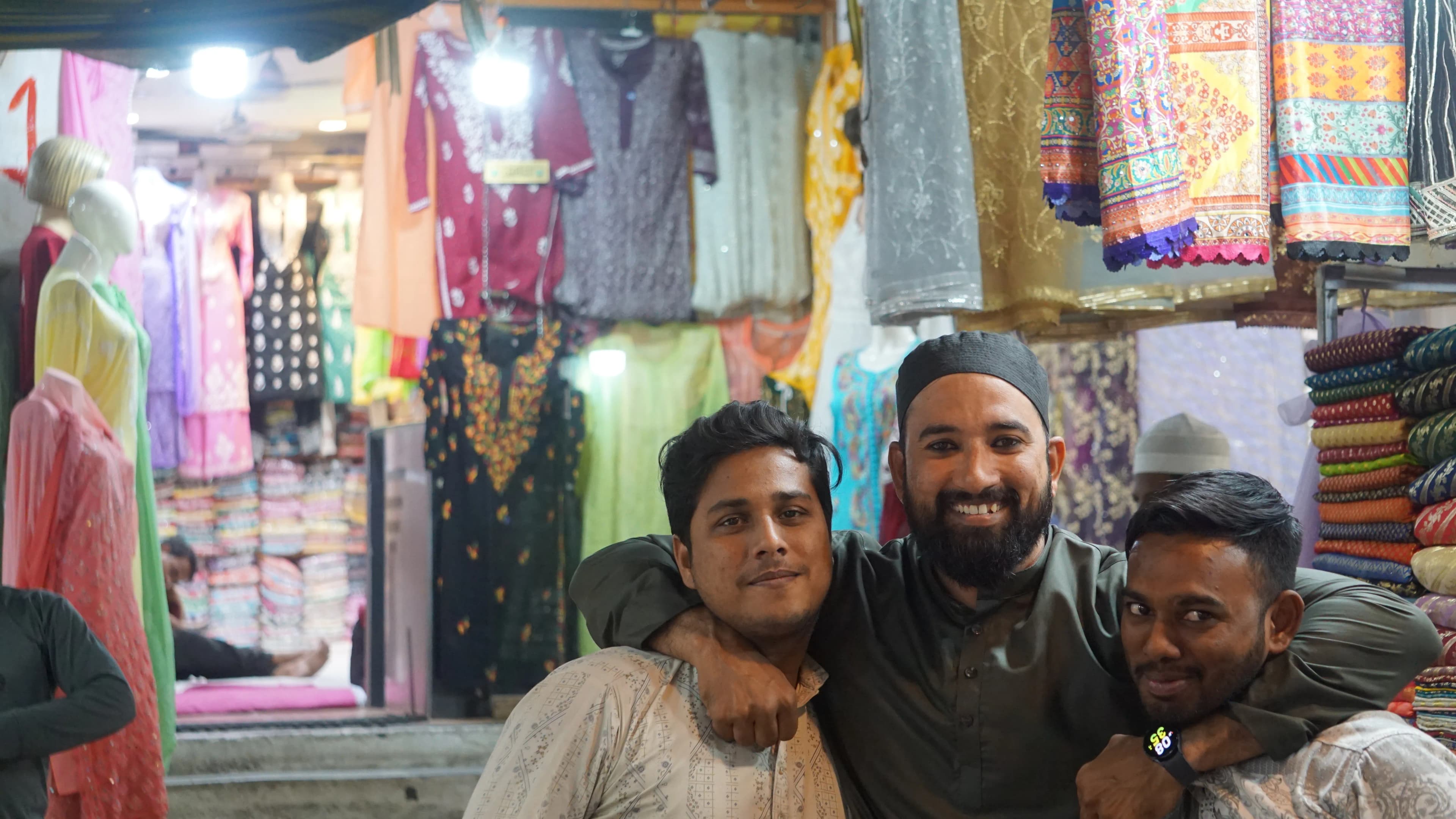 Three friends who wanted a photo by the stall